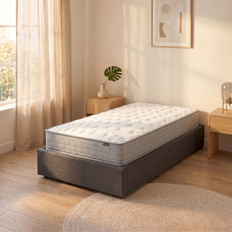 Thetis Single 25cm Pocket Spring Latex Mattress in Med Firm on grey upholstered bed base in neutral bedroom with wooden