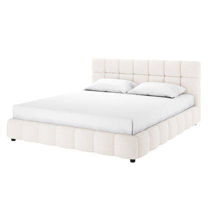 Nikias King Boucle Fabric Bed Frame in Cream White features a tall, tufted headboard and plush, rounded base in off-white bouclé. The platform design includes a mattress with fitted sheet and pillows.