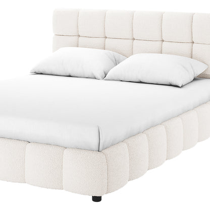 Nikias King Boucle Fabric Bed Frame in Cream White features a rounded, tufted headboard and matching base, with white bedding, showcasing its plush, modern design on a plain, clean background.