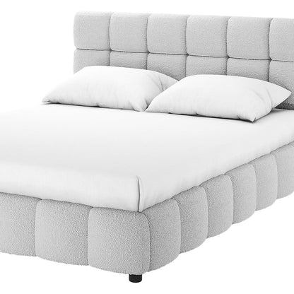 Nikias Queen Bouclé Fabric Bed Frame in Light Grey, featuring a tufted headboard and footboard with boucle texture, white bedding, and low-profile black legs, perfect for modern bedroom elegance.