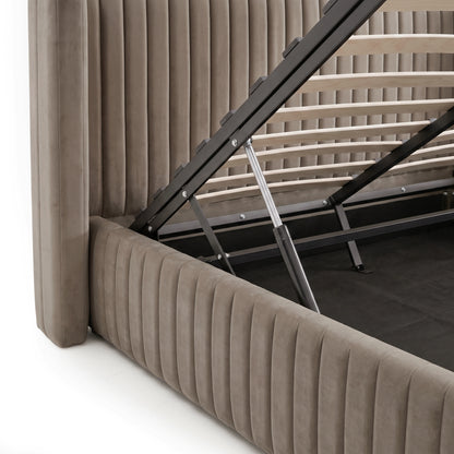 Warm grey velvet king bed frame with gas lift storage mechanism and wooden slats raised to reveal under-bed compartment
