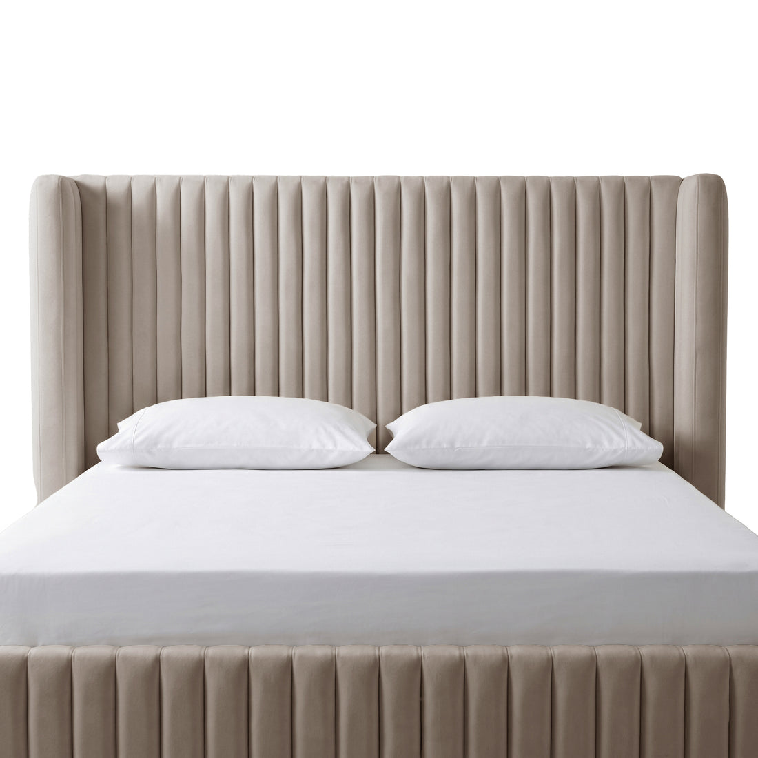Warm grey velvet king bed frame with vertical channel tufting, white fitted sheet and two white pillows, white background