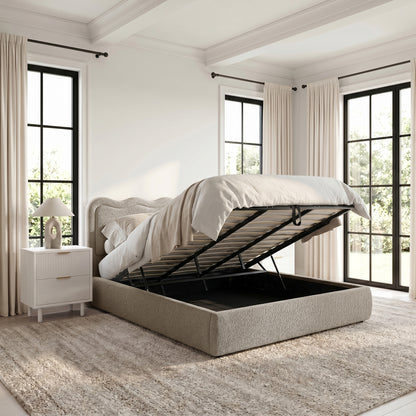 Beige upholstered storage bed with lift-up base in bright bedroom