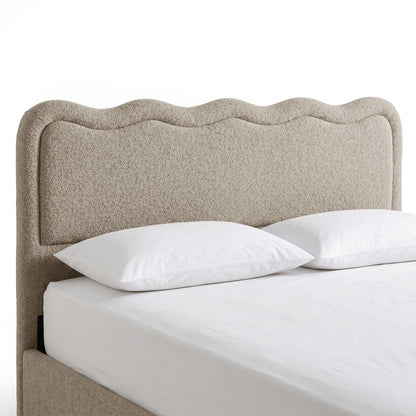 Beige boucle upholstered king bed frame with scalloped headboard and white bedding