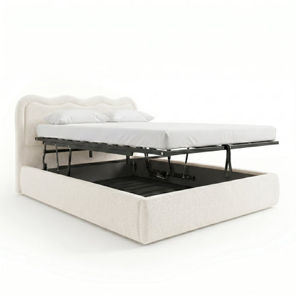 Cream white boucle queen bed with gas lift storage base raised to show under-bed compartment, scalloped headboard and white