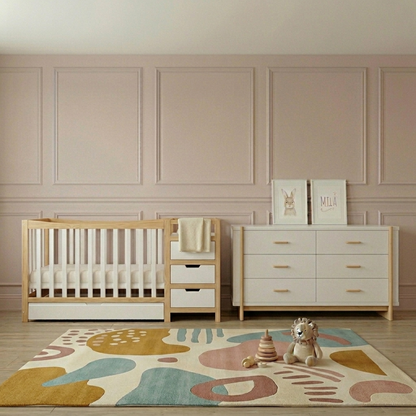 Natural and white timber baby cot with integrated storage drawers in nursery