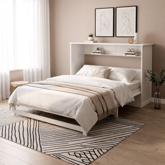 Penn Queen Smart Foldout Wall Bed with Storage in White, featuring a built-in headboard with shelves, dressed in white linens. Accented by abstract art, sheer curtains, and a light geometric rug.