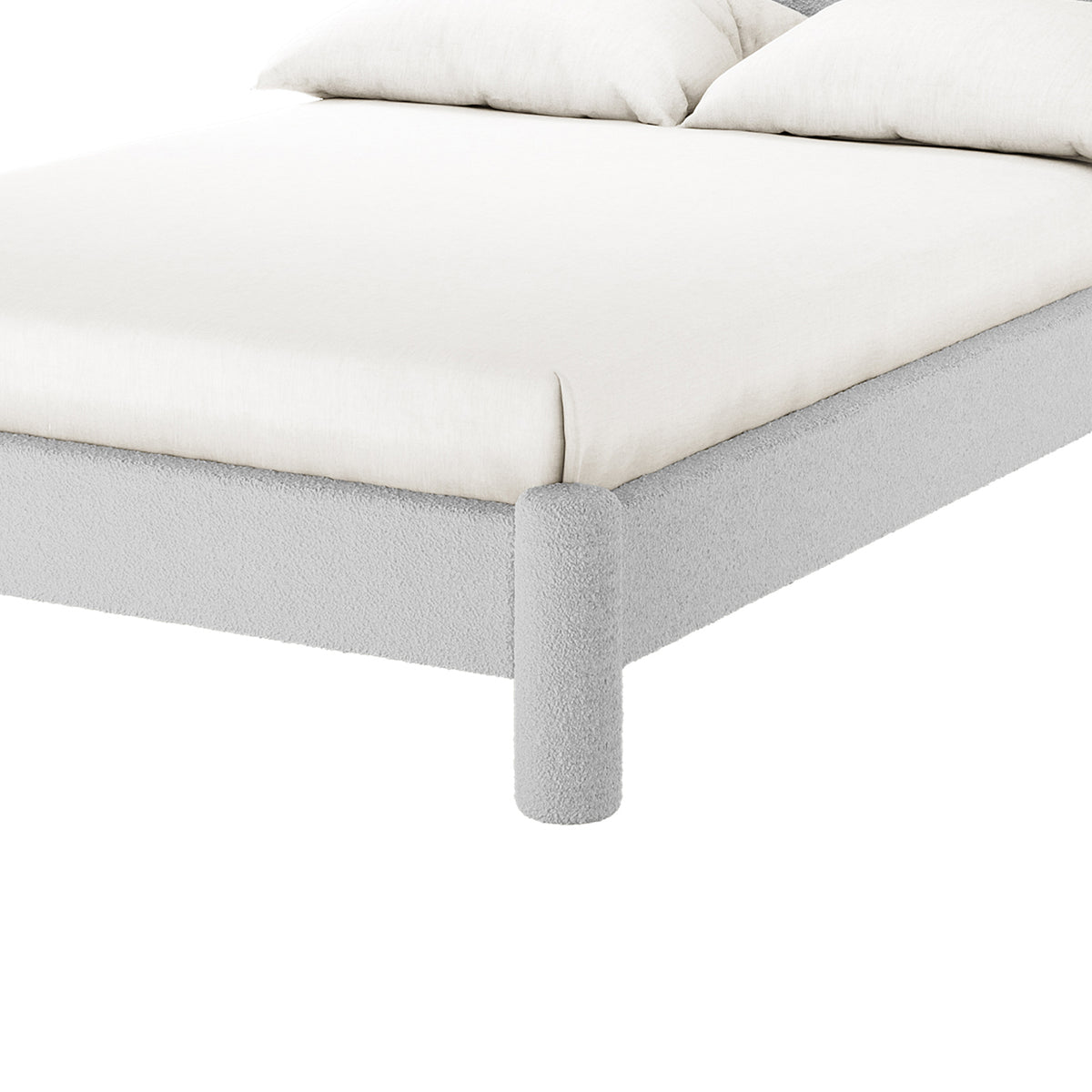 Rhoda Double Boucle Fabric Bed Frame in Light Grey, featuring a low-profile design with a soft-fabric frame, cylindrical legs, and an oversized curved headboard for modern comfort and style.