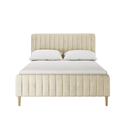 Seneca Double Upholstered Velvet Bed – Sandy White features a light beige fabric with a tall, channel-tufted headboard and matching footboard on slender wooden legs, showcasing modern elegance and comfort.