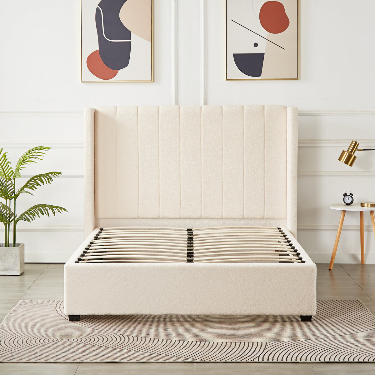 Septima & Fulvia Bouclé Queen Bed Base & Headboard in Cream White, featuring a tall, wing-style, vertically channel-stitched headboard, with visible wooden slats, complemented by a neutral rug and abstract art prints.