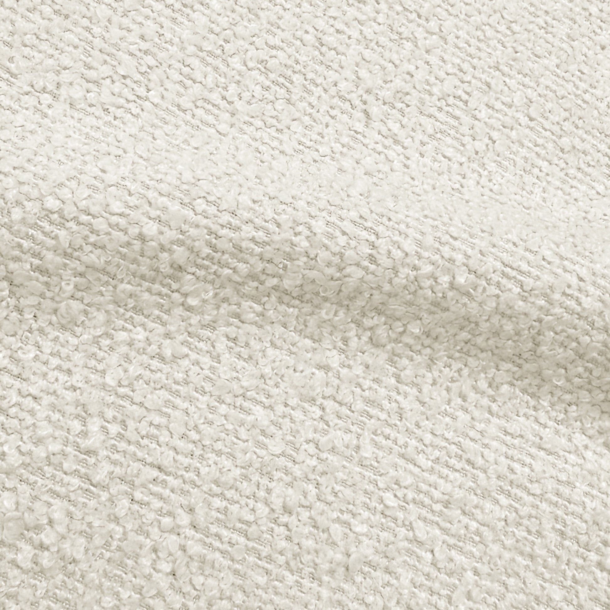 Close-up of boucle cream white fabric texture showing woven detail