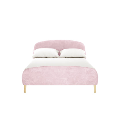 Theron Double Upholstered Velvet Bed in Light Pink features a low-profile design with a gently curved headboard, crisp white bedding, two pillows, and tapered wooden legs for modern elegance.