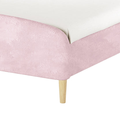 Theron Double Upholstered Velvet Bed in Light Pink, showcasing a pale pink fabric-covered base, white mattress topper, and a single tapered wooden leg, highlighting its elegant and sturdy design.