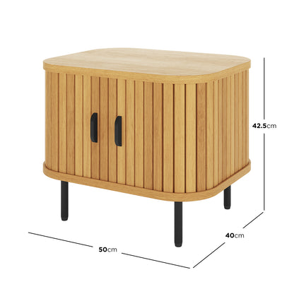 Aaron 50cm Bedside Table with Sliding Doors features a compact wooden cabinet with vertical slatted panels, two black handles, and slim metal legs, offering modern elegance and practical storage.