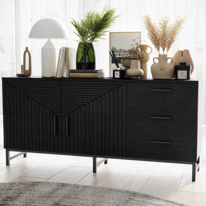 Black fluted sideboard buffet with geometric panel doors, three drawers and metal legs styled with vases, lamp and books
