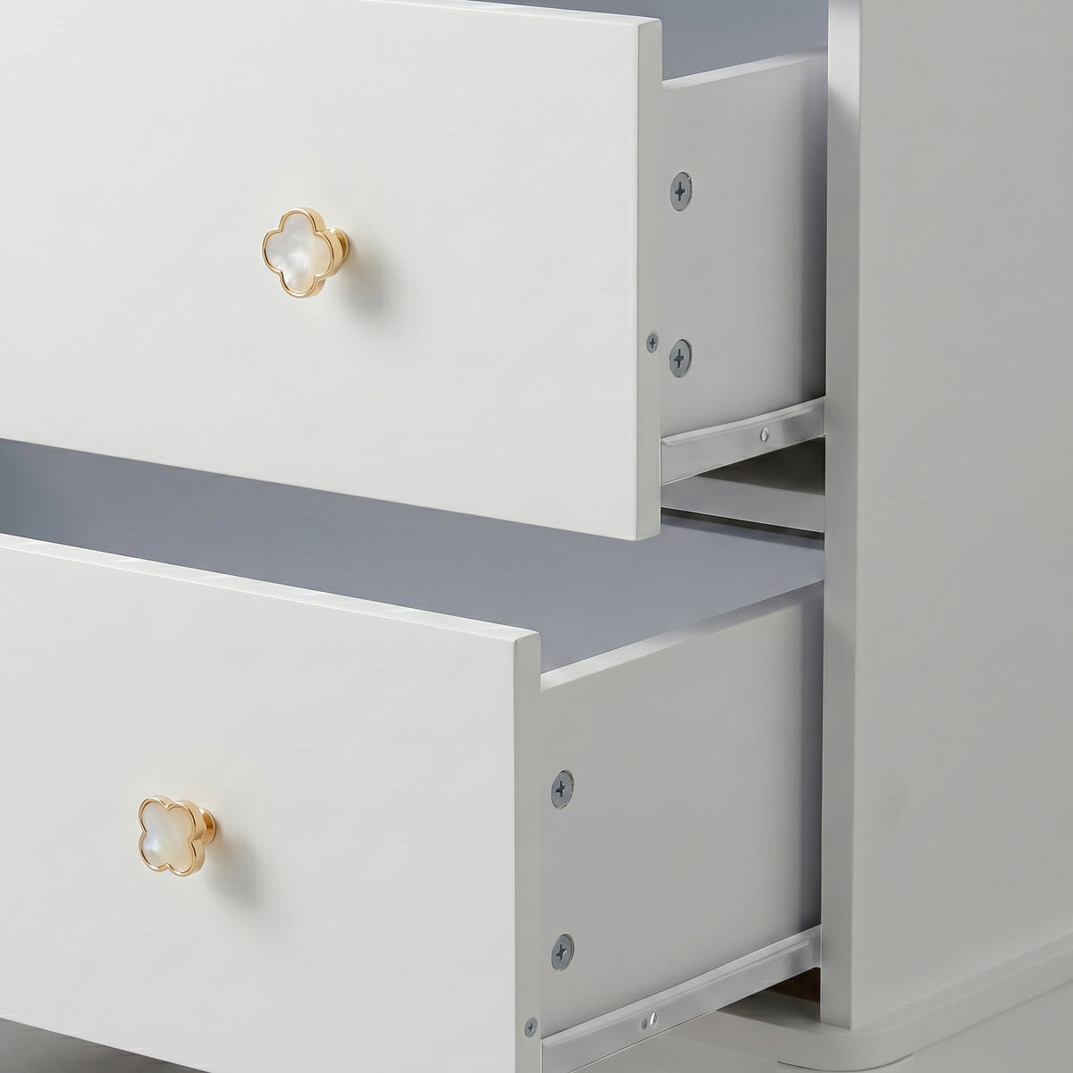White three-drawer dresser with gold flower knobs on white background