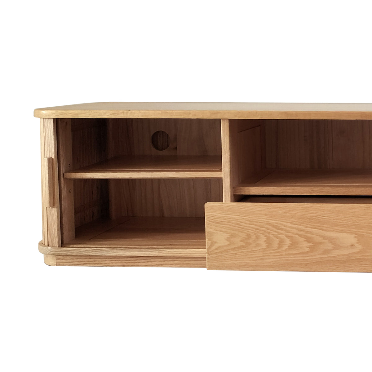 Close-up of Eddie 200cm Hardwood Oak TV Entertainment Unit in Natural, featuring a left open cubby with a shelf and cable hole, and a right partially open drawer front.