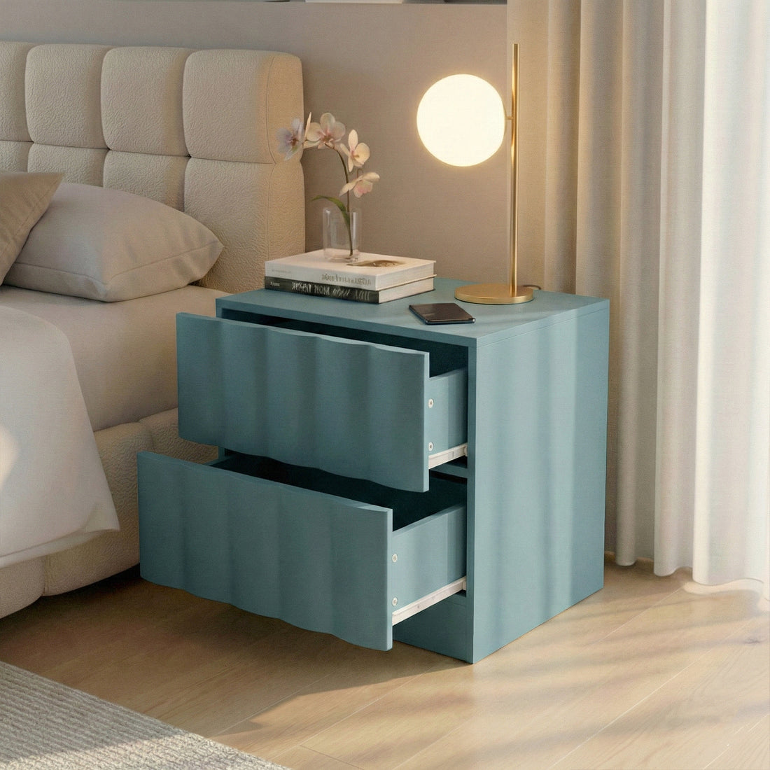 Hamish 2 Drawer Fluted Bedside Table in Sage with open drawers, shown beside bed with lamp, books and phone on top