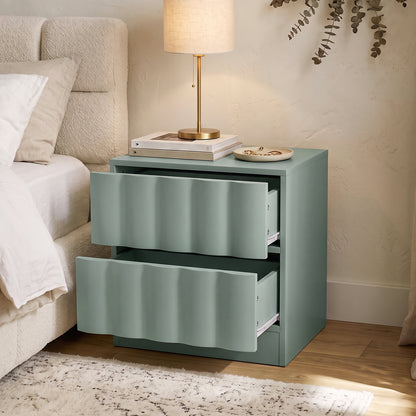 Hamish 2 Drawer Fluted Bedside Table in Sage with open drawers, shown beside bed with lamp, books and phone on top