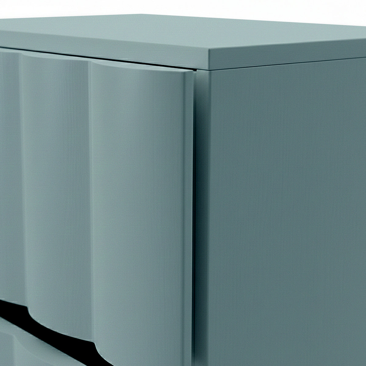 Close-up of sage green bedside table showing fluted drawer front and top edge detail