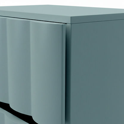 Close-up of sage green bedside table showing fluted drawer front and top edge detail