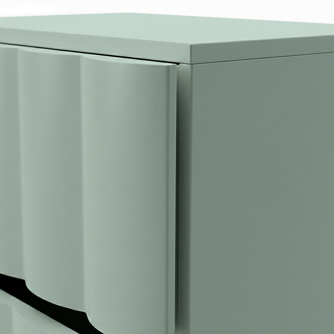Close-up of sage green bedside table showing fluted drawer front and top edge detail