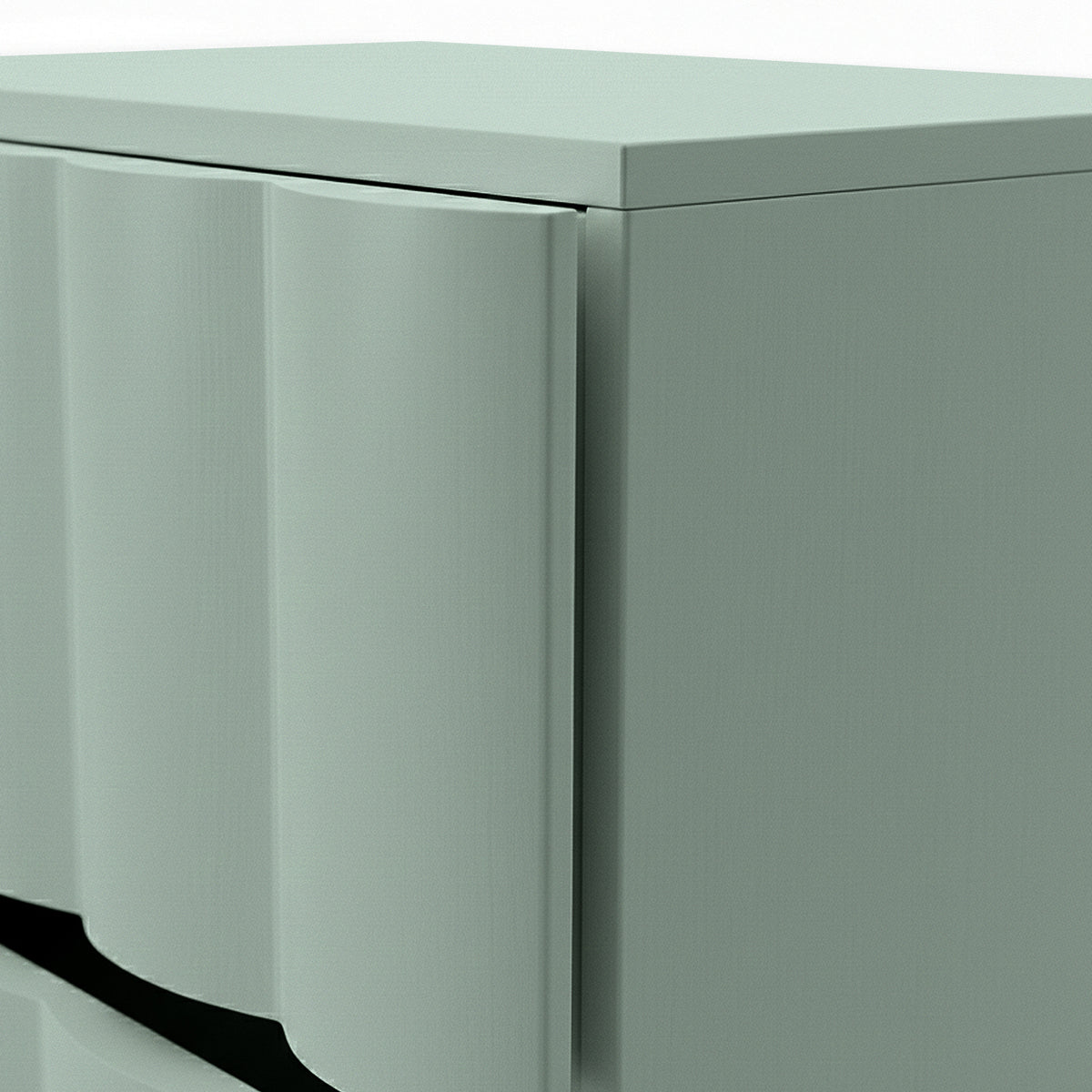 Close-up of sage green bedside table showing fluted drawer front and top edge detail