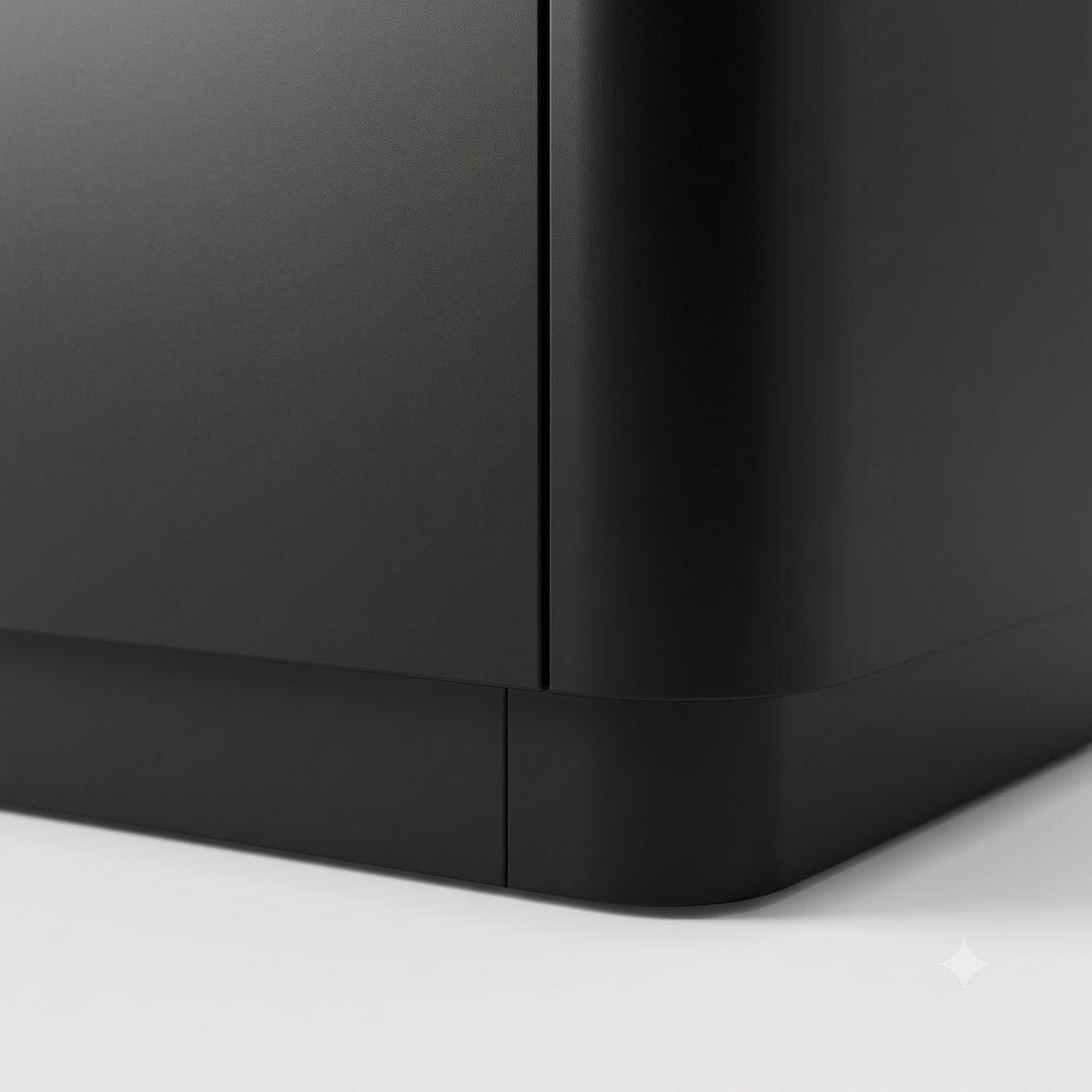 Close-up of the corner of a black furniture piece on a white background