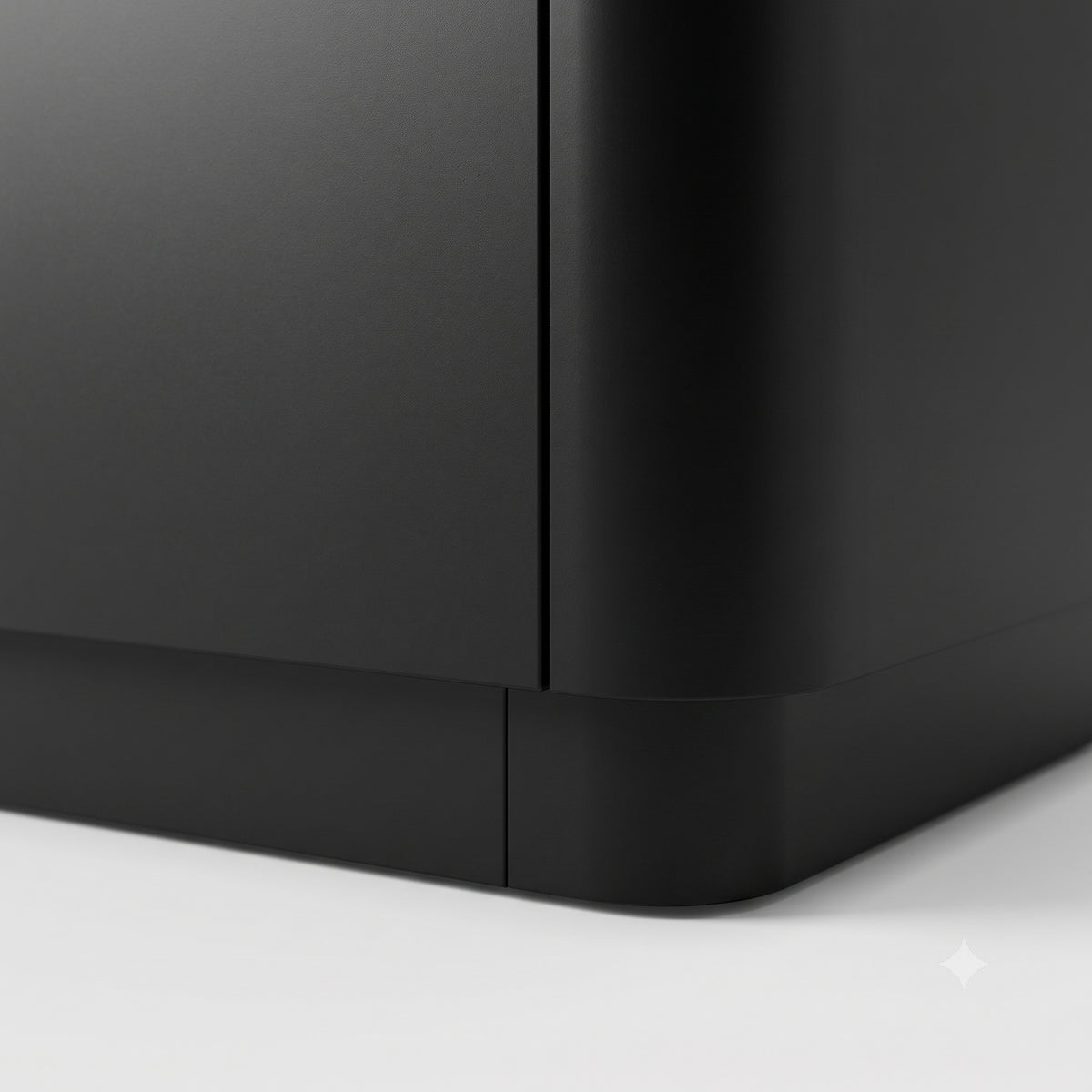 Close-up of the corner of a black furniture piece on a white background