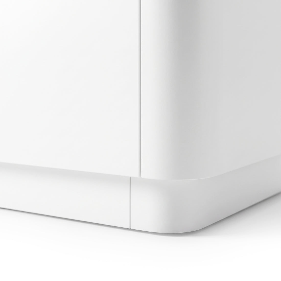 Close-up of the bottom corner of a white furniture piece