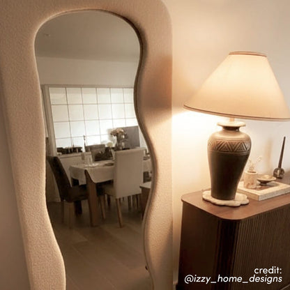 Sabrina 180cm Curved Full Length Mirror in Beige with wavy, textured frame reflecting a dining area