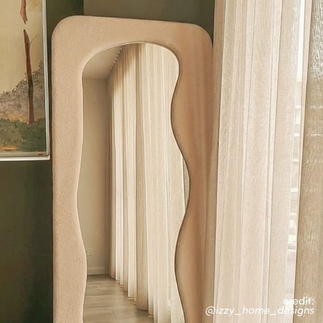 Sabrina 180cm Curved Full Length Mirror in Beige with wavy frame and textured finish, reflecting sheer curtains and hallway
