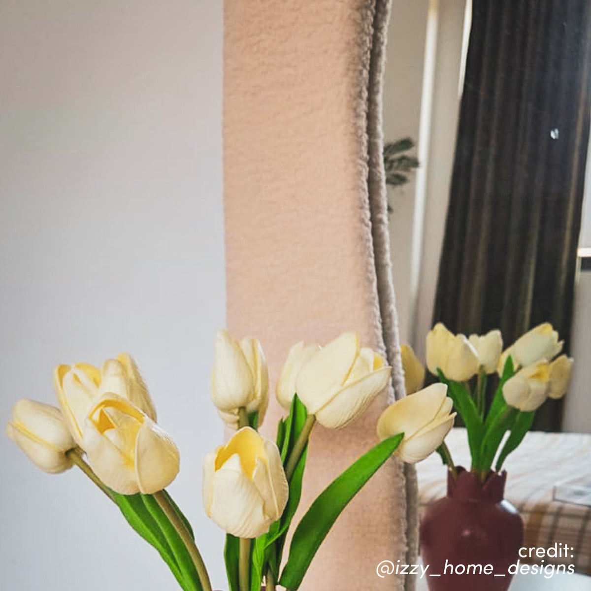 Sabrina 180cm Curved Full Length Mirror in Beige with textured wavy frame, displayed with cream tulips in plum vase