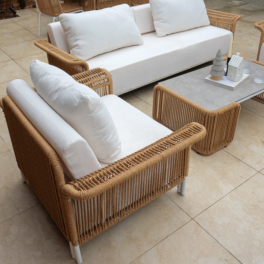 White pillow resting on a chair from the Avon 5-Seater Premium Aluminium Rattan Outdoor Lounge Set, highlighting its luxurious design and plush comfort, perfect for enhancing outdoor living spaces.