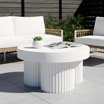 White round outdoor coffee table with a thick tabletop and a cluster of fluted pedestal legs.