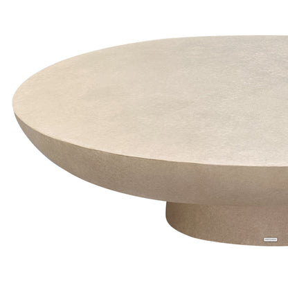Cassius oval outdoor concrete coffee table in ivory, close-up of curved edge and rounded base