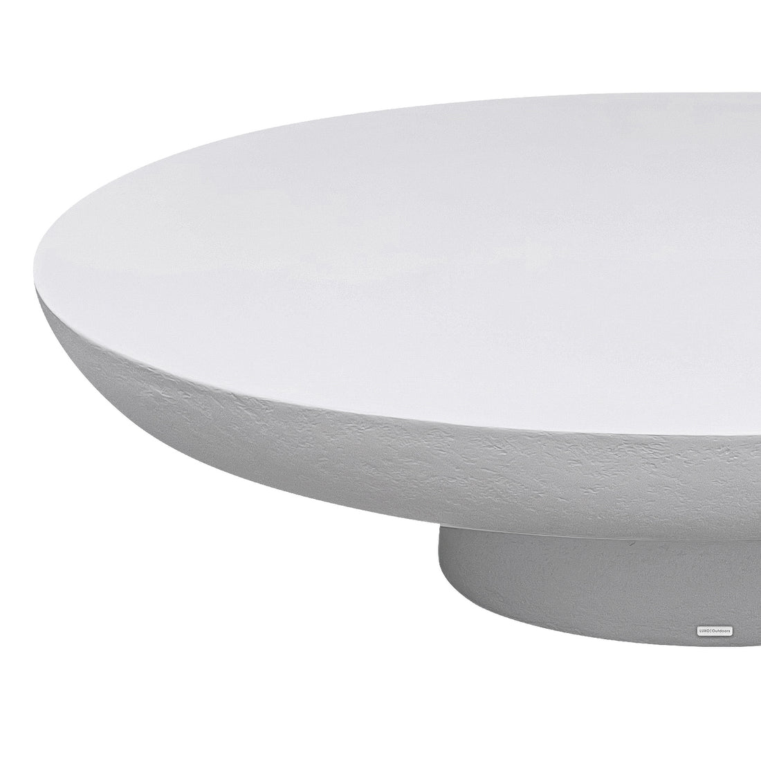 Cassius Oval Outdoor Concrete Coffee Table in White, close-up detail of smooth oval top and textured sculptural base