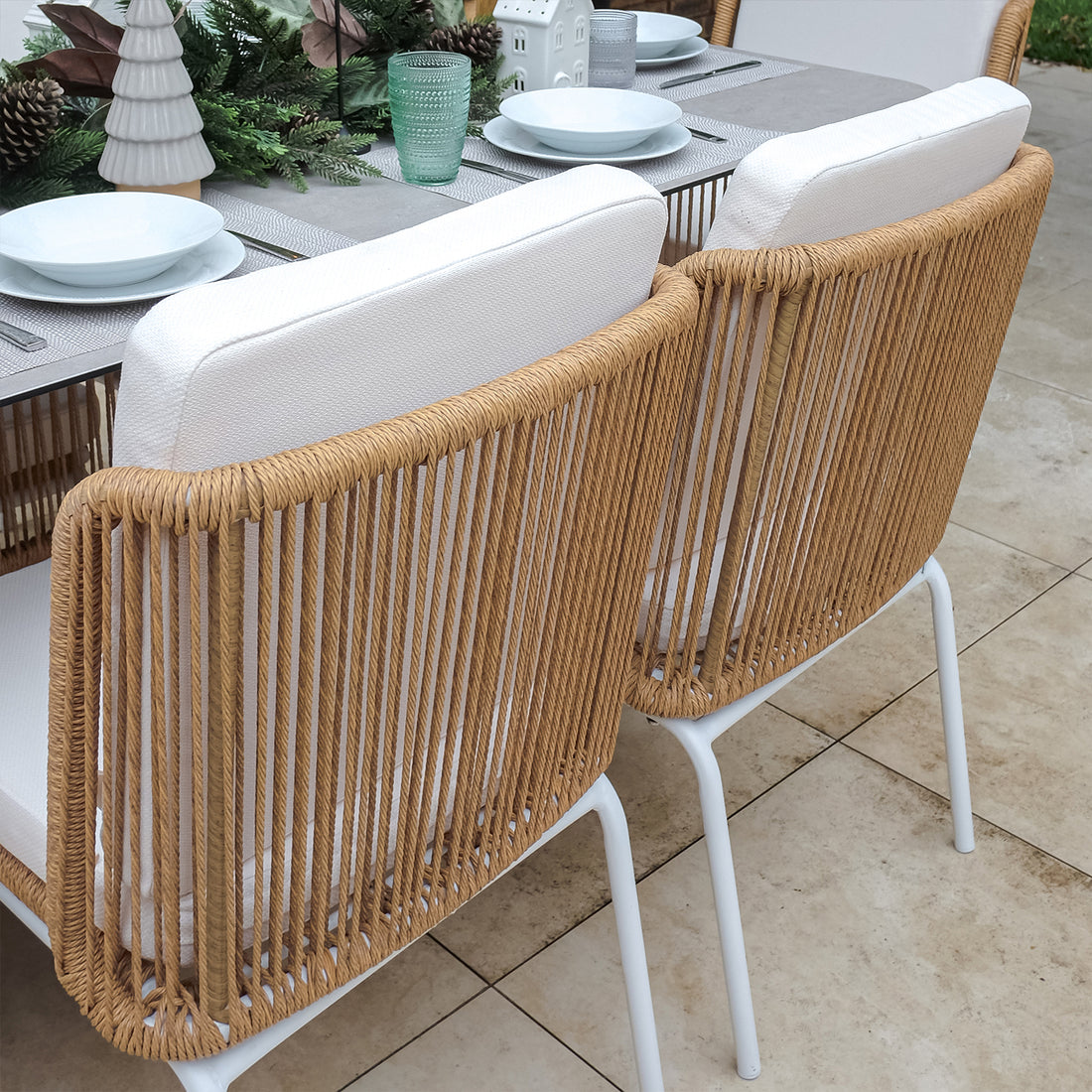Craigie Premium 6-Seater Outdoor Dining Set features a sleek ceramic glass table with a marble-like pattern and sturdy wicker chairs, ideal for stylish and durable outdoor dining.