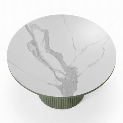 Evone Aluminium Outdoor Dining Table in Green features a round, white-marble-look tabletop with light gray veining, supported by a green, ribbed cylindrical pedestal base, ideal for stylish outdoor dining.