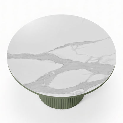 Evone Aluminium Outdoor Dining Table in Green features a round, white-marble-look tabletop with light gray veining, supported by a green, ribbed cylindrical pedestal base, ideal for stylish outdoor dining.