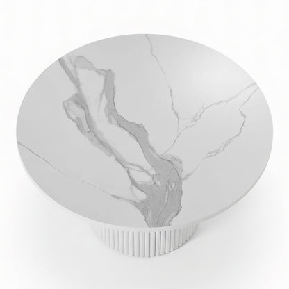 Evone 4 Seater Stone Outdoor Dining Table Set: Features a round, white marble tabletop with light veining on a fluted cylindrical base, ideal for stylish alfresco dining.

