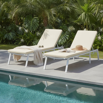 Jabari Outdoor Sun Loungers with Cushions Set of 2 in Cream White by a pool, featuring adjustable metal frames, padded