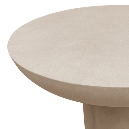 Close-up of the curved edge of the Jareth 80cm round concrete outdoor entry table in ivory