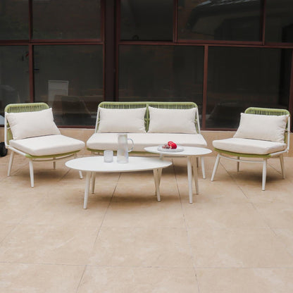 Lowanna 4pc Aluminium Rope Wicker Outdoor Lounge Set Mint Green features a two-seater sofa, armless chairs, and two coffee tables on a patio, showcasing modern design and comfort.