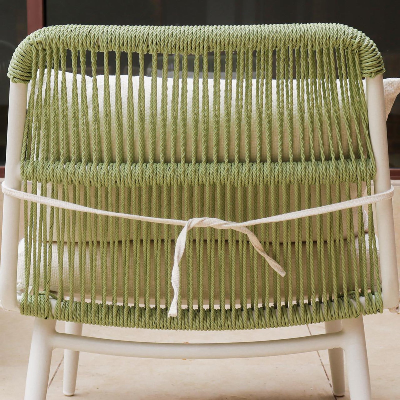Lowanna 4pc Aluminium Rope Wicker Outdoor Lounge Set Mint Green showcasing a close-up of durable rope construction, part of a stylish chair tied to the set, ideal for enhancing outdoor spaces.