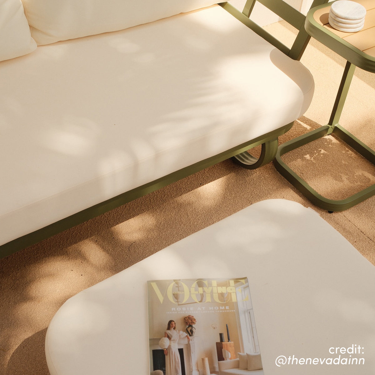 Paloma Modular Outdoor Lounge Set in Olive Green with cream cushions, curved side table and white coffee table with magazine