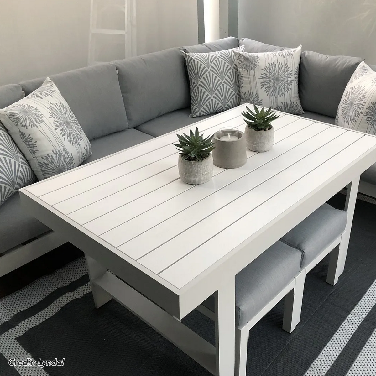 Portland Outdoor Corner Sofa Lounge with Footstools, white table with succulents and candle