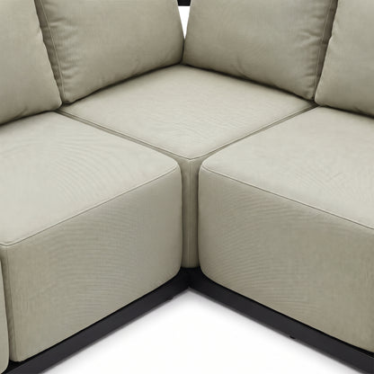 Close-up of a corner section of a beige sectional sofa on a white background