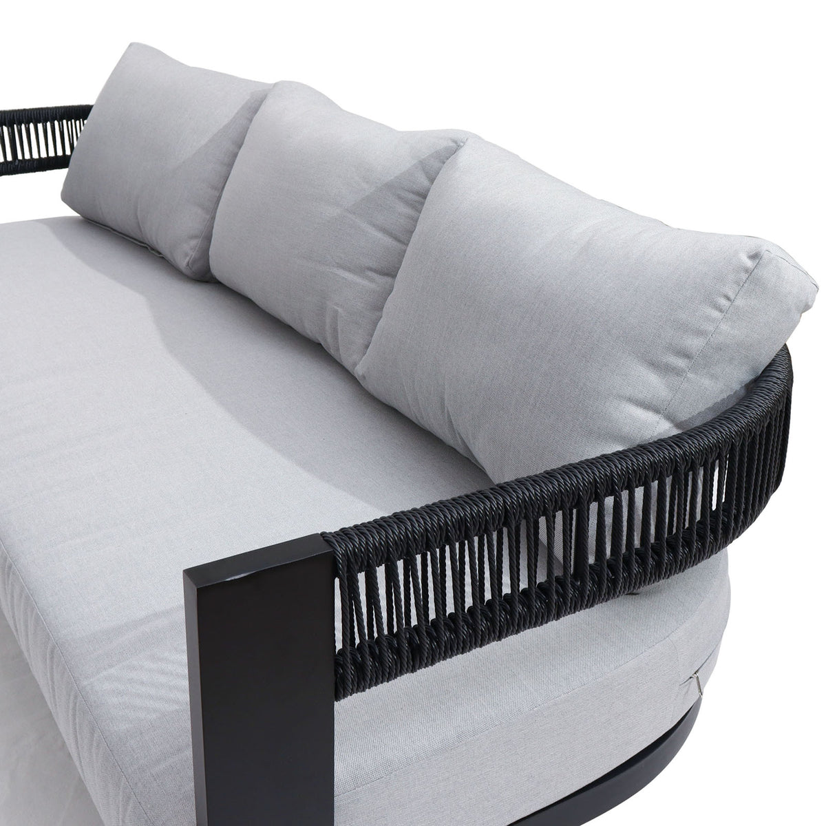 Sorrelle 5 Seater Wicker Outdoor Sofa Set in Black, featuring a round base with a black metal frame, woven-rope sides, light-gray seat cushions, and three matching back pillows.