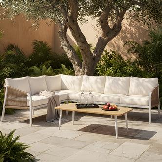 Vernon 4pc Rattan 6-Seater Aluminum L-shaped outdoor lounge set with a white aluminum frame, woven rope armrests, and cream cushions, paired with a timber-top coffee table.